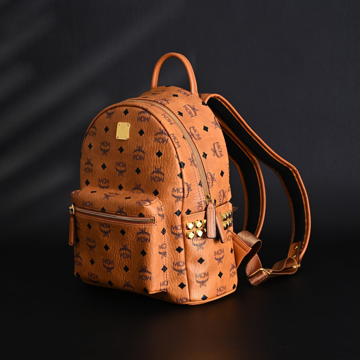 Mcm Stark Visetos Medium Backpack – Cognac Monogram with Gold-Tone Studs - Cognac with Black Monogram Print